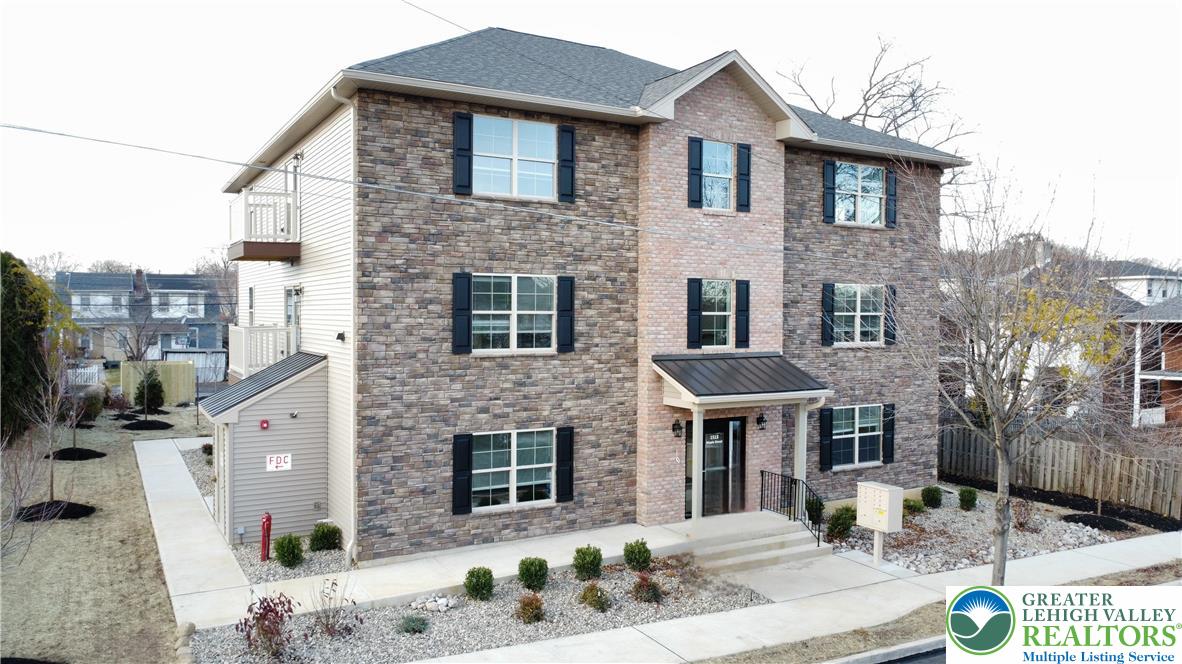 1513 Maple Street, Unit 101 Bethlehem, PA 18017 - Photo 1 of 18 a front view of a house with a yard