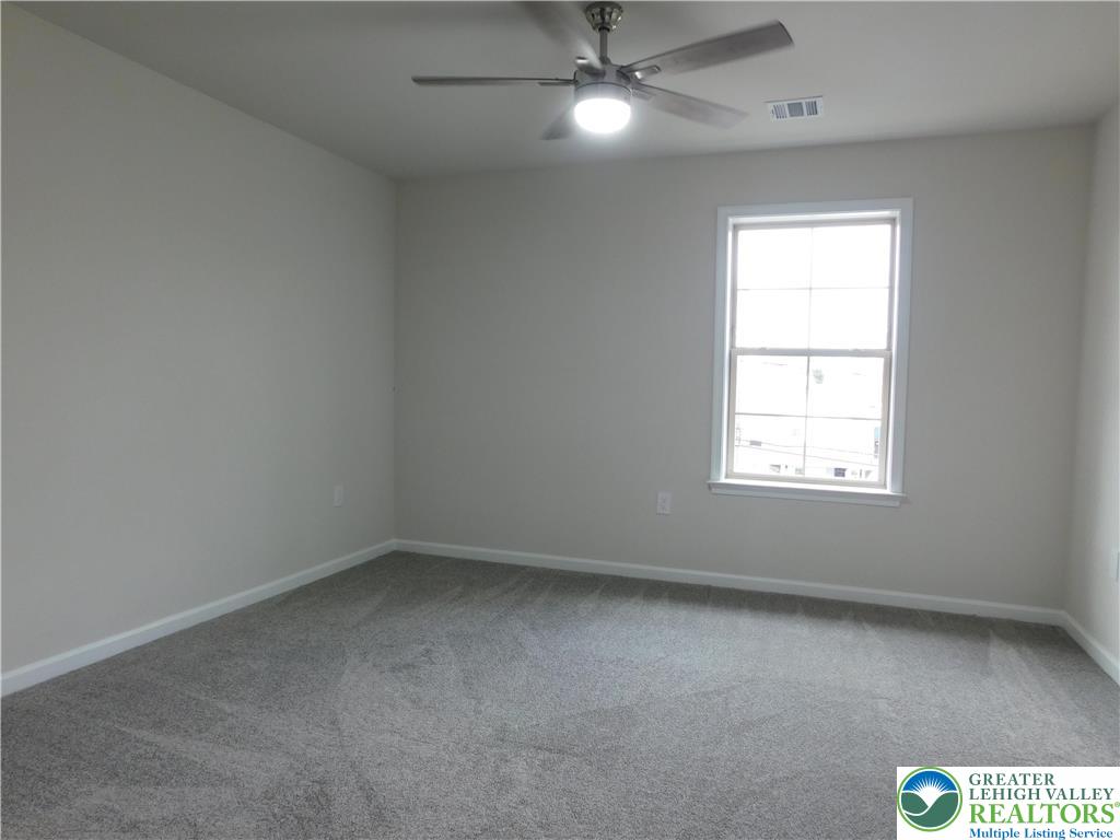 1513 Maple Street, Unit 101 Bethlehem, PA 18017 - Photo 13 of 18 an empty room with a window and ceiling fan