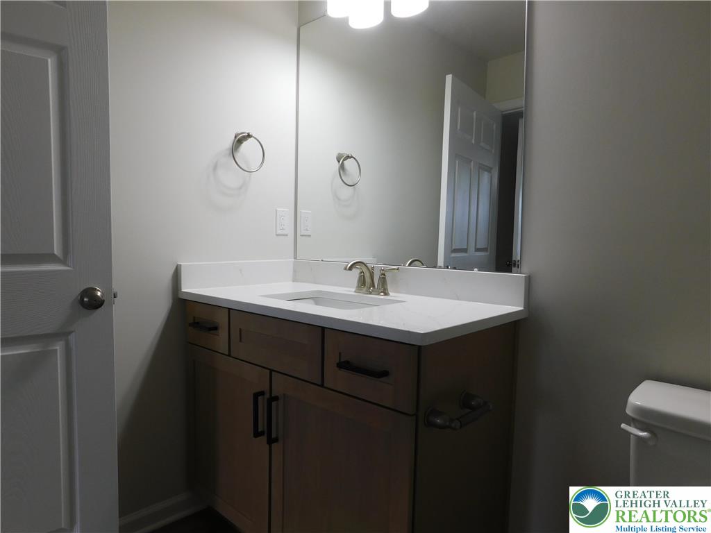 1513 Maple Street, Unit 101 Bethlehem, PA 18017 - Photo 17 of 18 a bathroom with a sink and a mirror