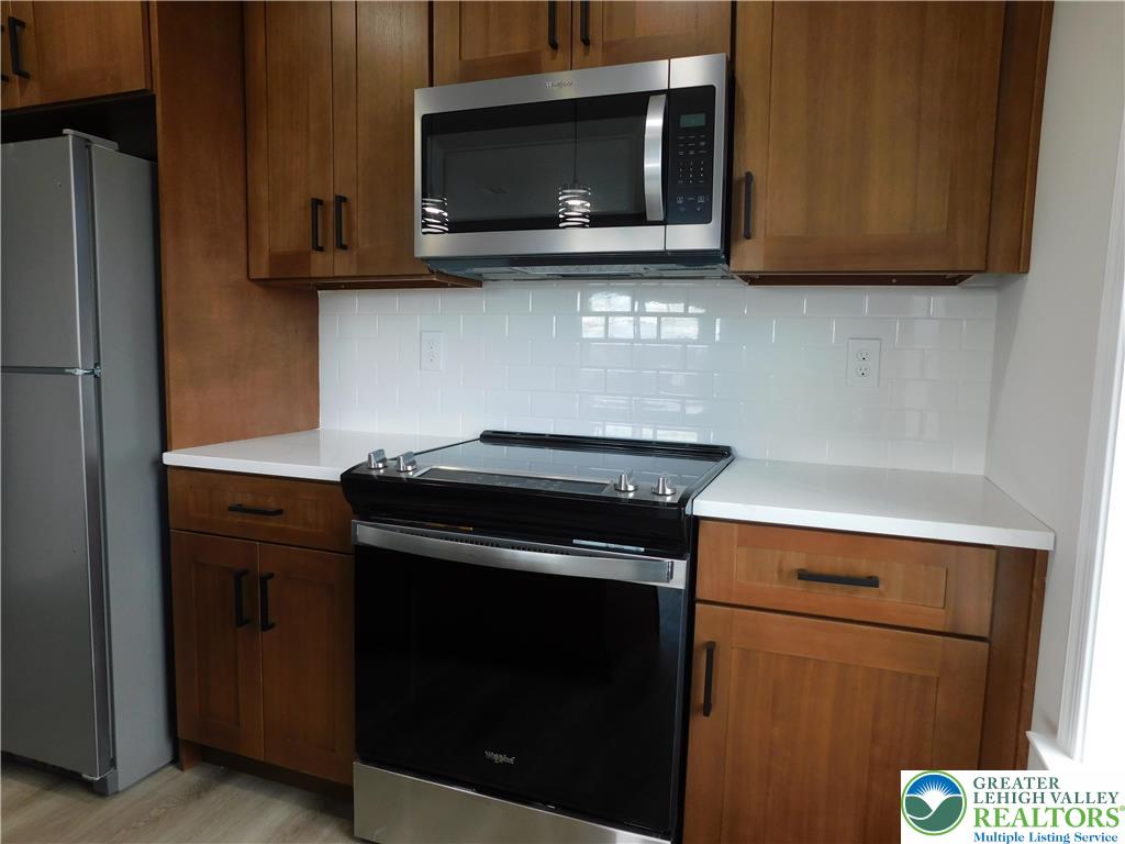 1513 Maple Street, Unit 101 Bethlehem, PA 18017 - Photo 7 of 18 a kitchen with a stove microwave and sink