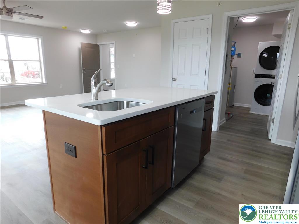 1513 Maple Street, Unit 101 Bethlehem, PA 18017 - Photo 8 of 18 a kitchen with kitchen island a sink stainless steel appliances and cabinets