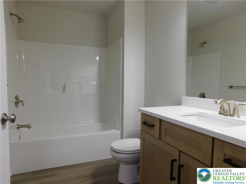1513 Maple Street, Unit 101 Bethlehem, PA 18017 - Photo 10 of 18 a bathroom with a sink toilet vanity and bathtub