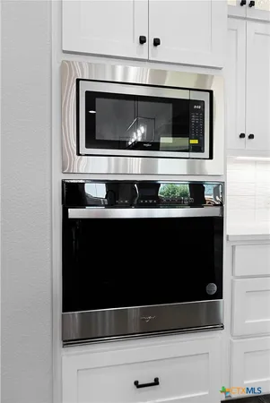 a kitchen with a stove and a microwave