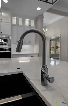 a view of an empty room with wooden floor and a fireplace