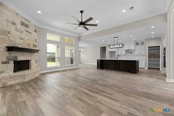 a view of a house with a big yard and large trees