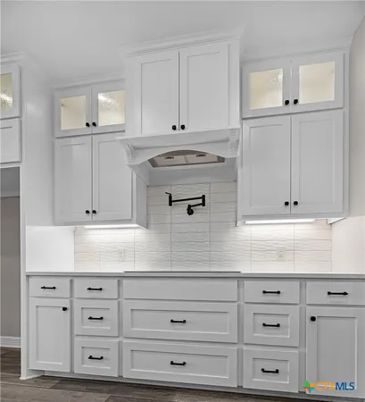 a view of kitchen with white cabinets
