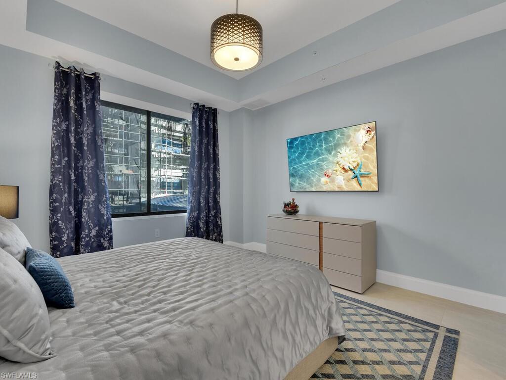 1111 Central Avenue, Unit 216 Naples, FL 34102 - Photo 15 of 50 a bedroom with a bed and a window