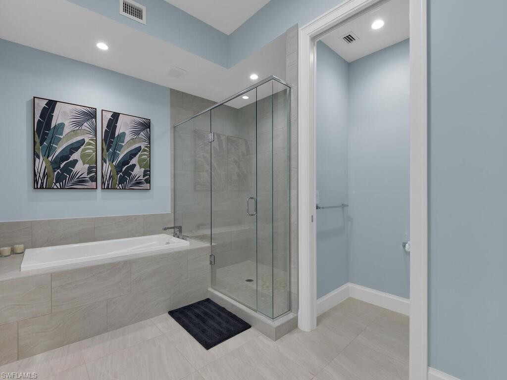 1111 Central Avenue, Unit 216 Naples, FL 34102 - Photo 18 of 50 a bathroom with a bathtub and a shower