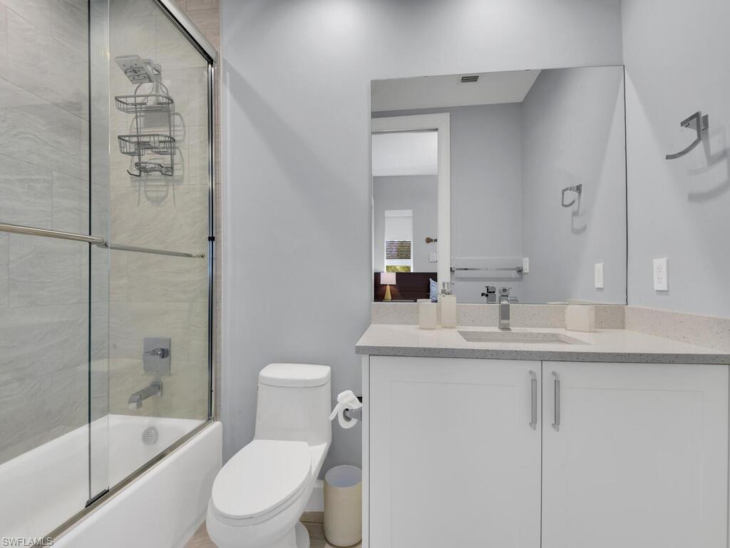 1111 Central Avenue, Unit 216 Naples, FL 34102 - Photo 22 of 50 a bathroom with a sink a toilet and shower