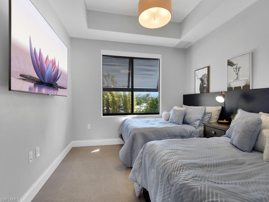1111 Central Avenue, Unit 216 Naples, FL 34102 - Photo 23 of 50 a bedroom with a bed and window