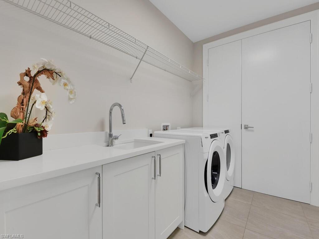 1111 Central Avenue, Unit 216 Naples, FL 34102 - Photo 27 of 50 a utility room with dryer and washer