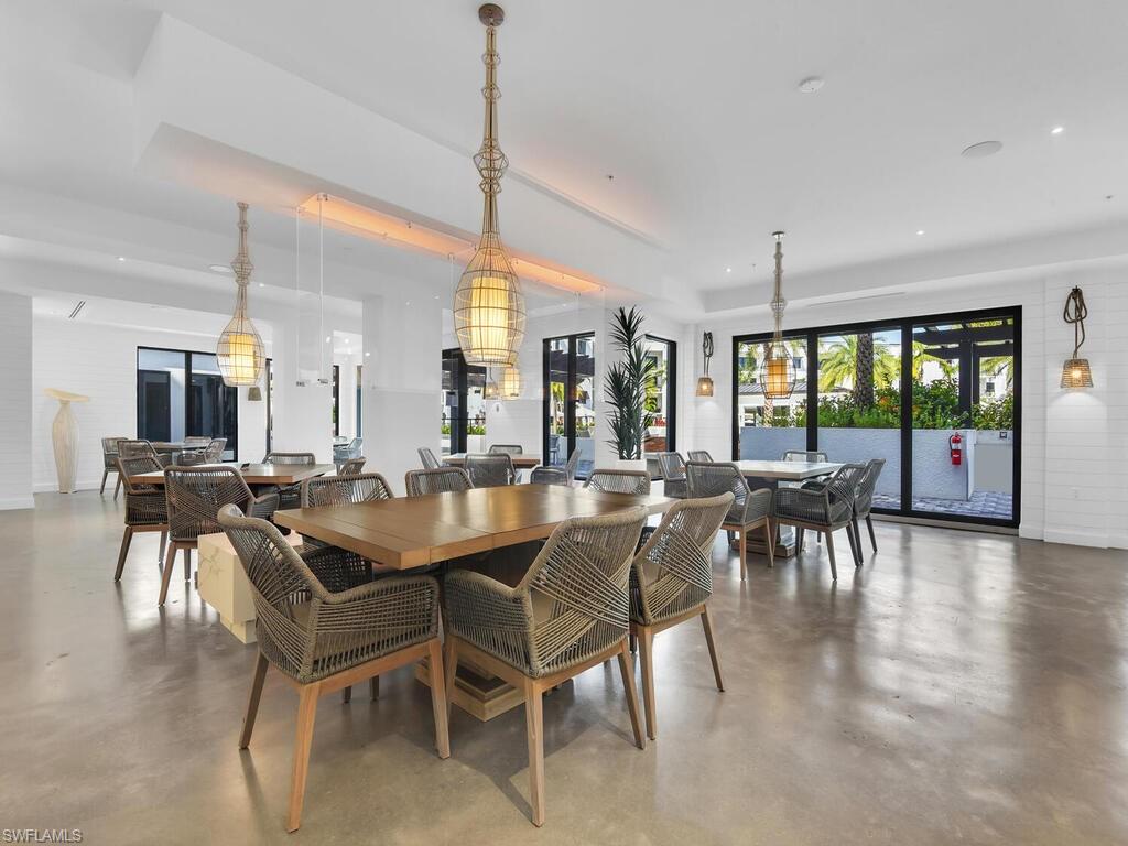 1111 Central Avenue, Unit 216 Naples, FL 34102 - Photo 36 of 50 a dining area with furniture and a view of kitchen
