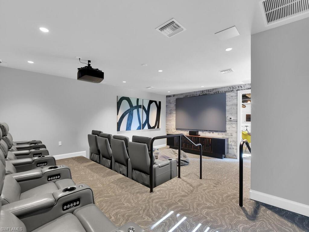 1111 Central Avenue, Unit 216 Naples, FL 34102 - Photo 48 of 50 a living room with furniture and a gym machine