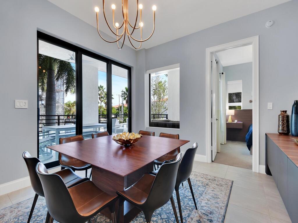 1111 Central Avenue, Unit 216 Naples, FL 34102 - Photo 10 of 50 a view of a dining room with furniture window and wooden floor
