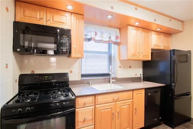 a kitchen with stainless steel appliances granite countertop a stove and a microwave