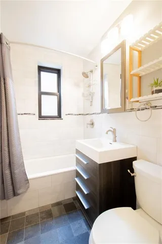 a bathroom with a sink a toilet and bathtub