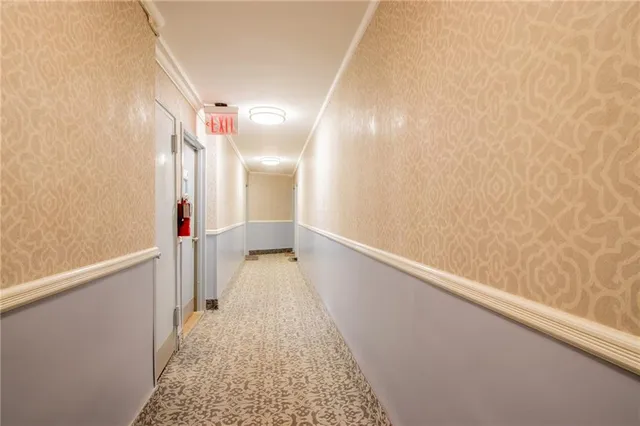 a room with gym equipment and a rug