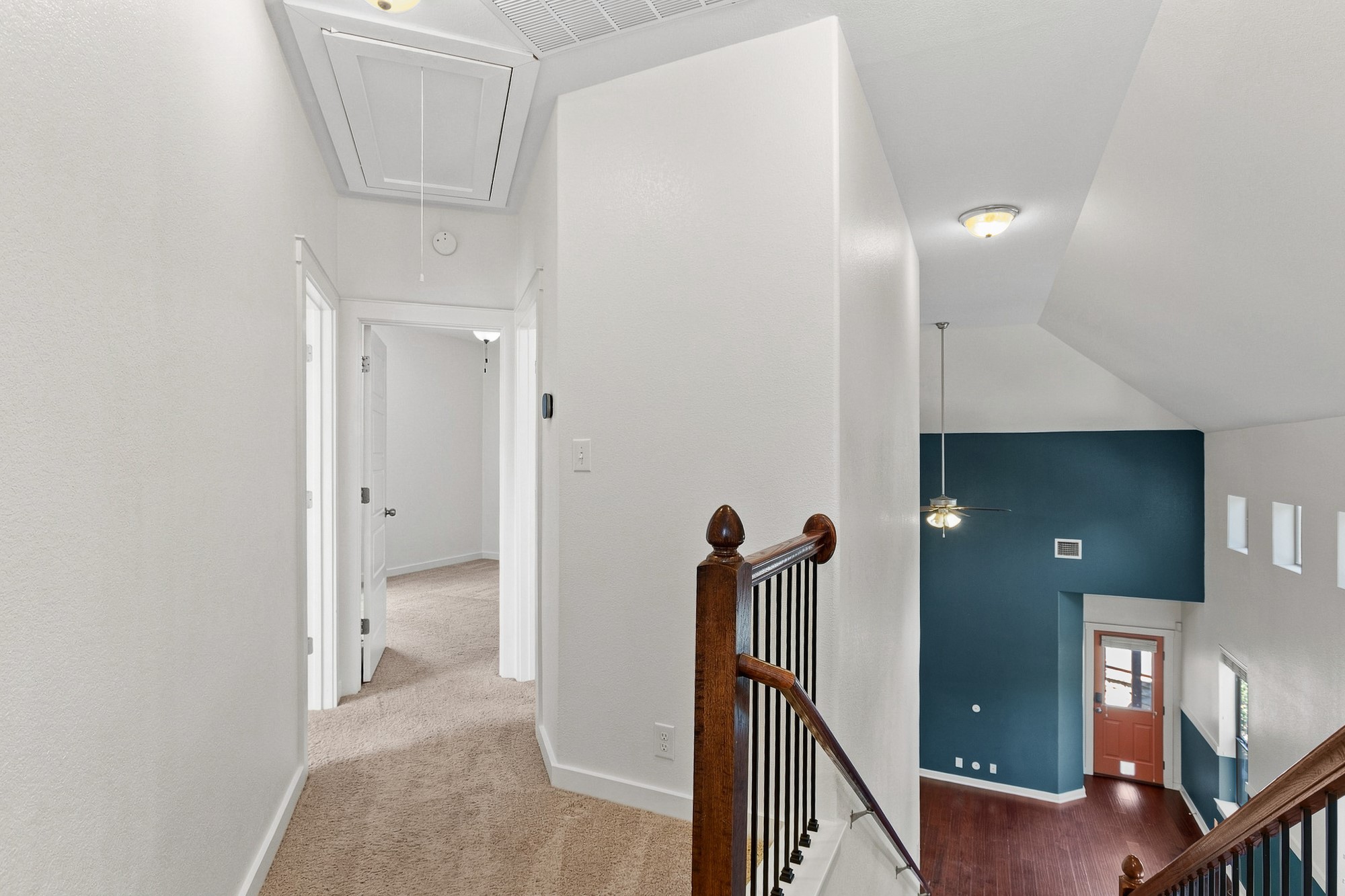 2101 Rivers Edge Way, Unit 25 Austin, TX 78741 - Photo 13 of 20 An upper landing features plush carpeting and overlooks a lower level with warm wood floors.