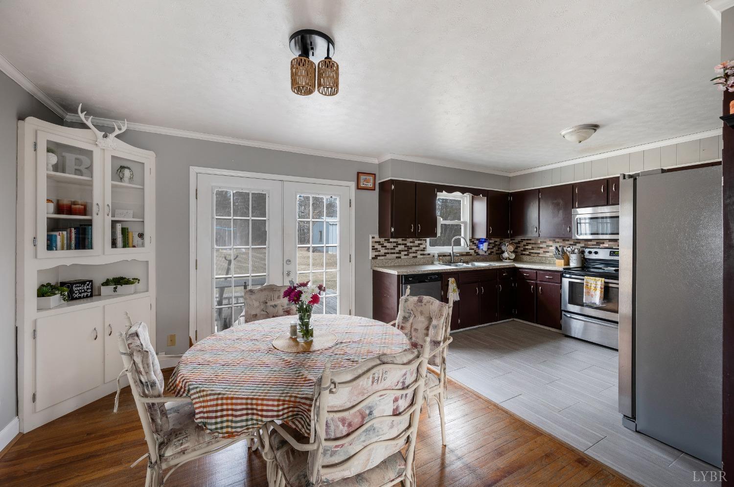 463 Eldon Road Appomattox, VA 24522 - Photo 6 of 32 a kitchen with a table chairs refrigerator and microwave