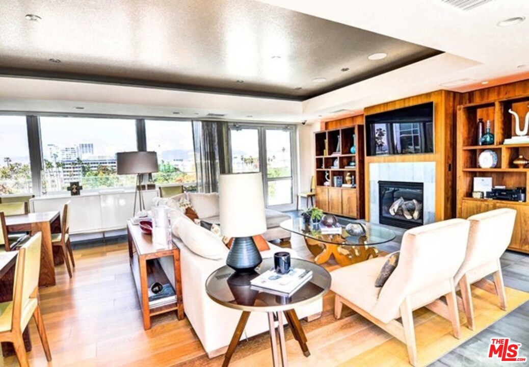 1705 Ocean, Unit 212 Santa Monica, CA 90401 - Photo 16 of 17 a living room with fireplace furniture and a floor to ceiling window