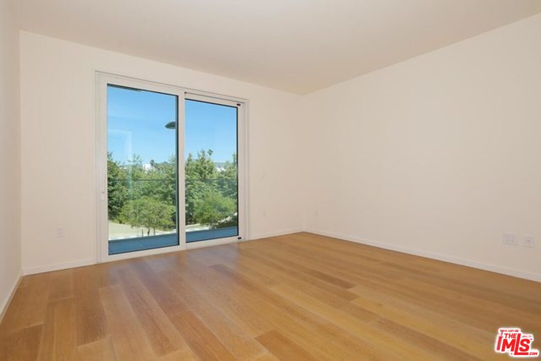 1705 Ocean, Unit 212 Santa Monica, CA 90401 - Photo 5 of 17 a view of an empty room with wooden floor and a window