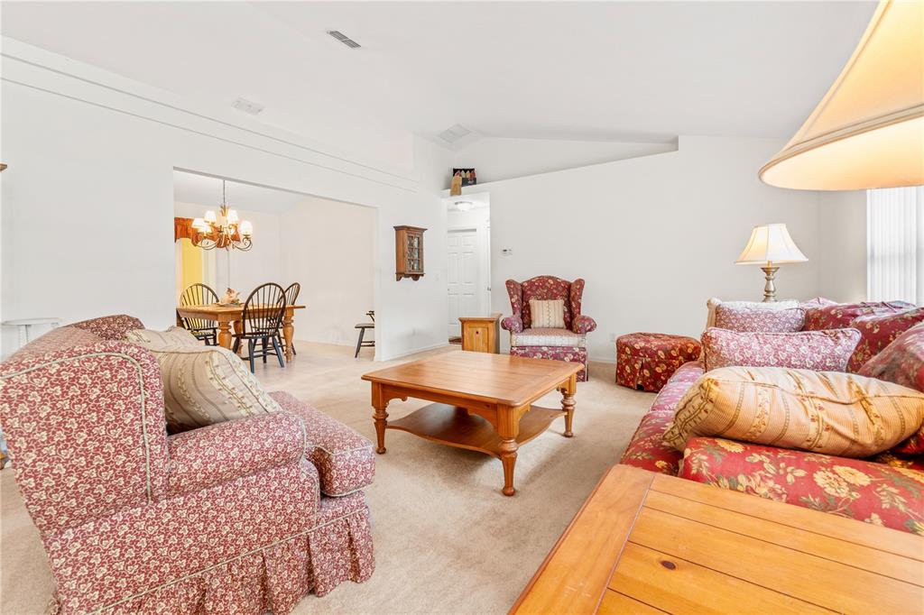 10151 Southwest 41st Terrace Ocala, FL 34476 - Photo 5 of 37 a living room with furniture and a lamp