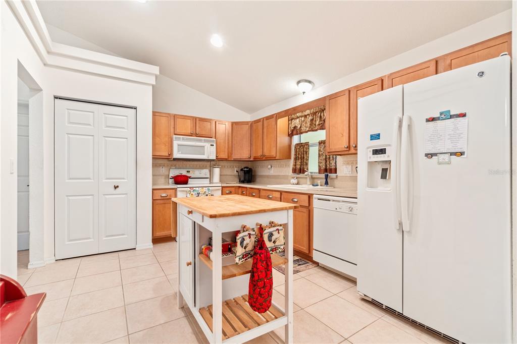 10151 Southwest 41st Terrace Ocala, FL 34476 - Photo 10 of 37 a kitchen with stainless steel appliances granite countertop a refrigerator and a stove top oven