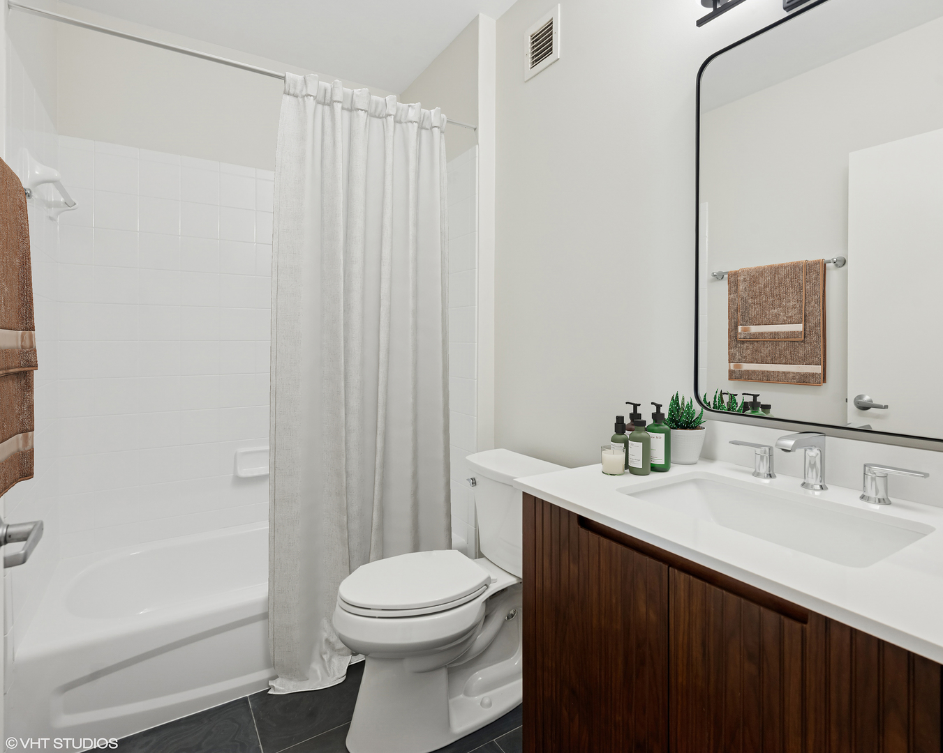 630 North State Street, Unit 1406 Chicago, IL 60654 - Photo 16 of 18 a bathroom with a sink a toilet and shower