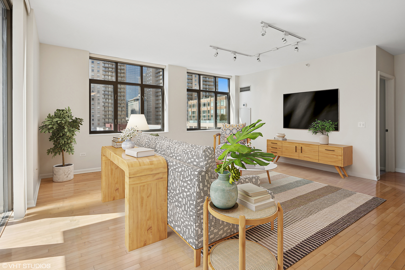 630 North State Street, Unit 1406 Chicago, IL 60654 - Photo 7 of 18 a living room with furniture and a flat screen tv