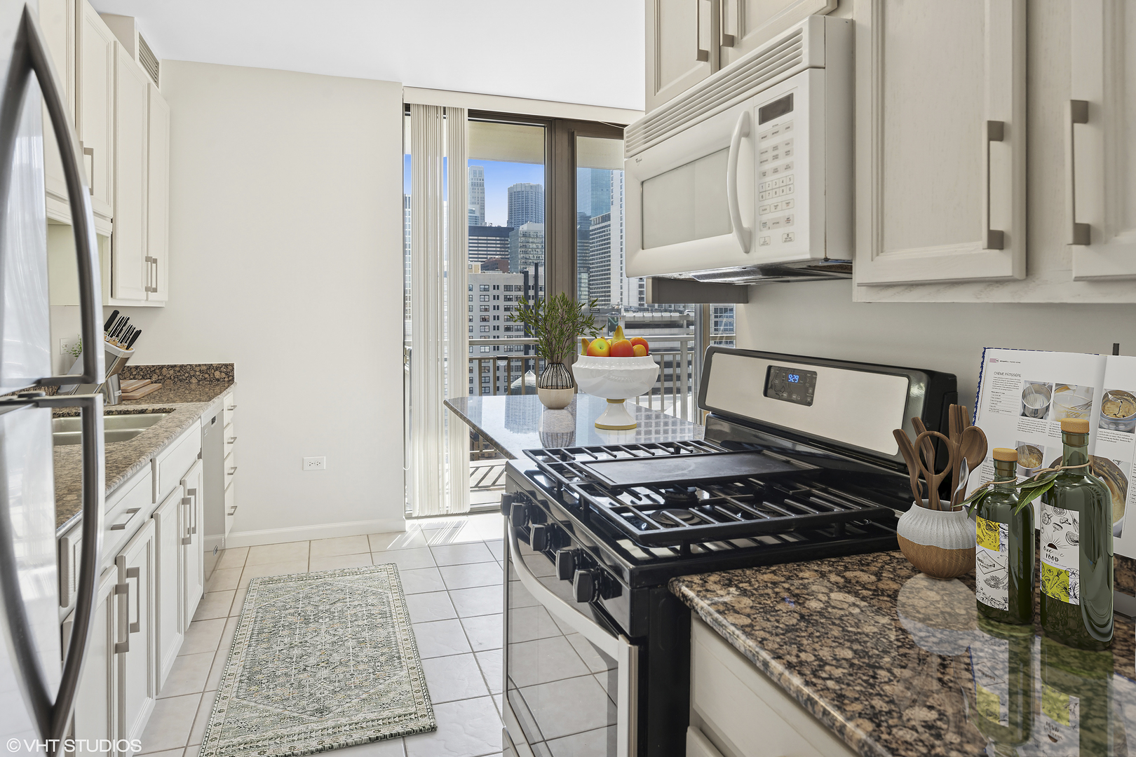 630 North State Street, Unit 1406 Chicago, IL 60654 - Photo 10 of 18 a kitchen with stainless steel appliances granite countertop a stove and a sink
