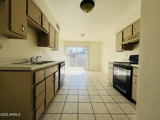 a kitchen with a sink and a stove top oven