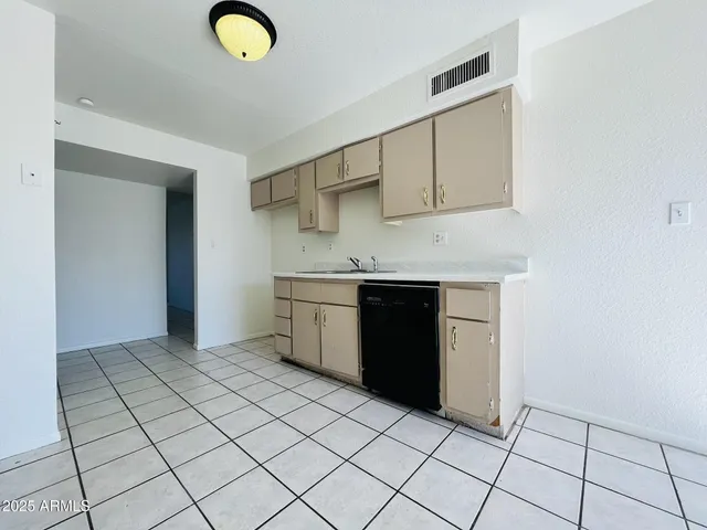 a kitchen with stainless steel appliances granite countertop a sink and cabinets