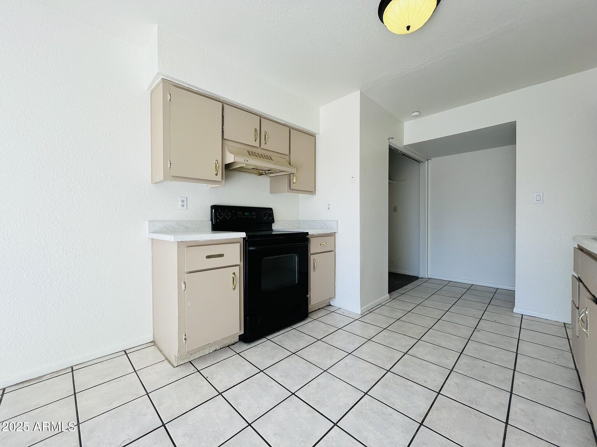 3807 North 23rd Drive, Unit 2 Phoenix, AZ 85015 - Photo 4 of 11 a kitchen with stainless steel appliances a sink and cabinets