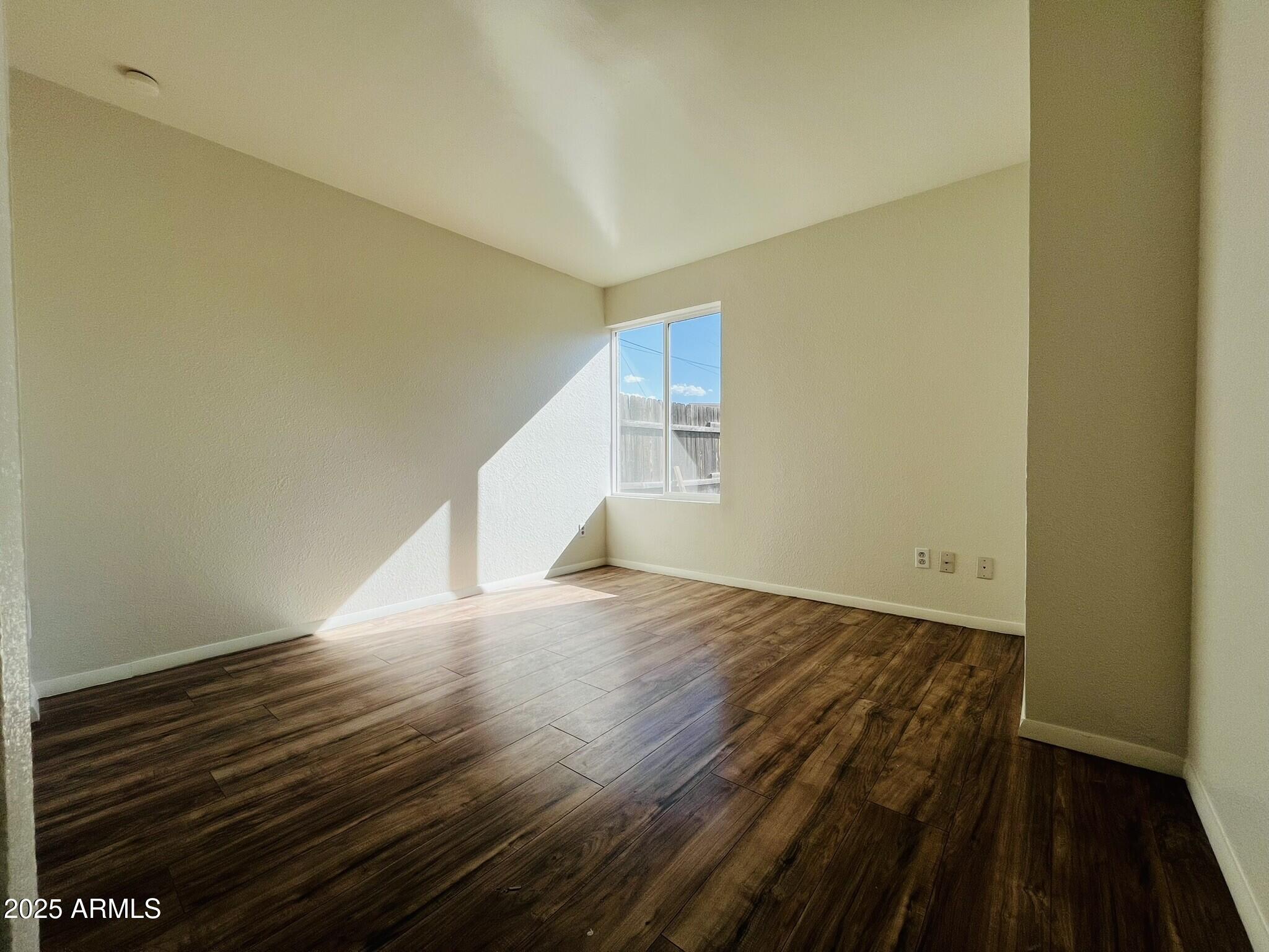 3807 North 23rd Drive, Unit 2 Phoenix, AZ 85015 - Photo 6 of 11 a view of an empty room with wooden floor