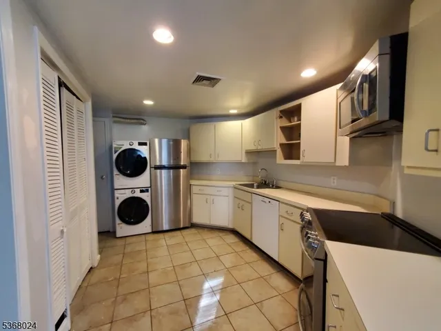 a kitchen with a sink a stove and cabinets