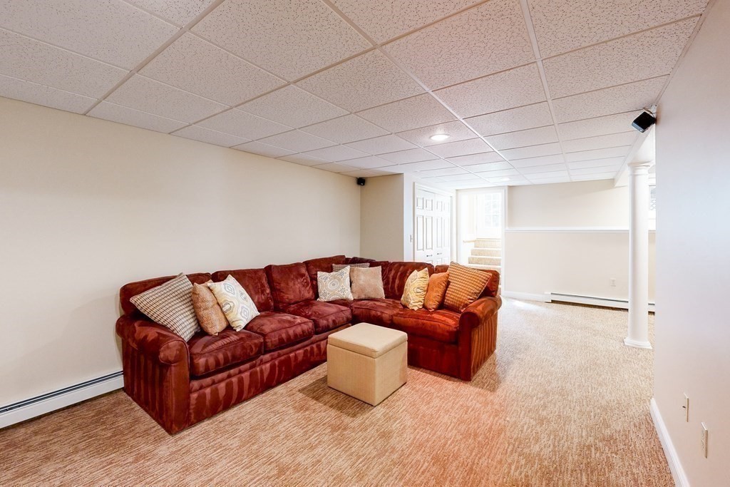 1 Chestnut Lane Medfield, MA 02052 - Photo 31 of 39 a living room with a couch and a ceiling fan