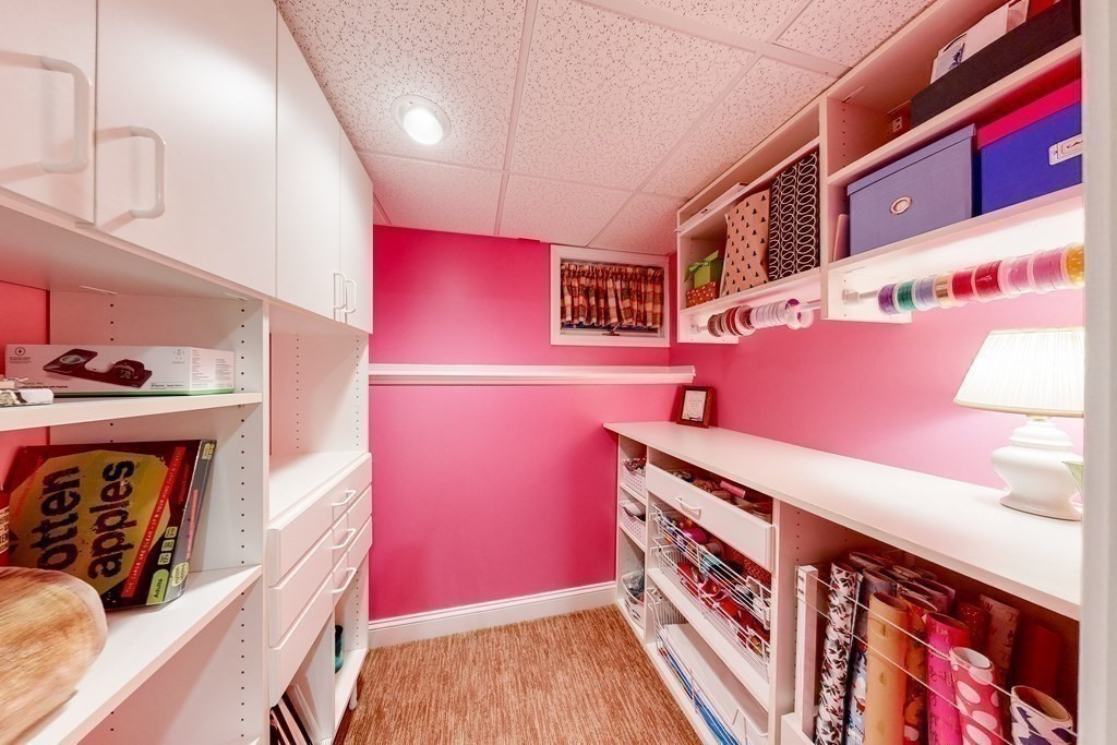 1 Chestnut Lane Medfield, MA 02052 - Photo 33 of 39 a hallway with pink walls and paintings on the wall