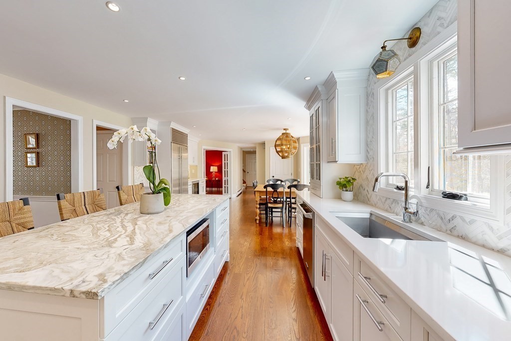 1 Chestnut Lane Medfield, MA 02052 - Photo 5 of 39 a large kitchen with granite countertop a large counter top a sink a window and a view of living room