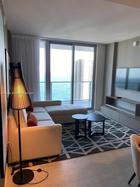 4010 South Ocean Drive, Unit R2305 Hollywood, FL 33019 - Photo 2 of 15 a living room with furniture and floor to ceiling window