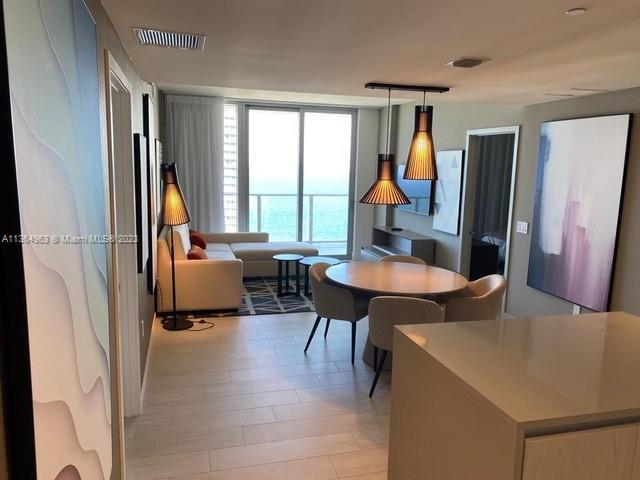 4010 South Ocean Drive, Unit R2305 Hollywood, FL 33019 - Photo 3 of 15 a living room with furniture a table and large windows