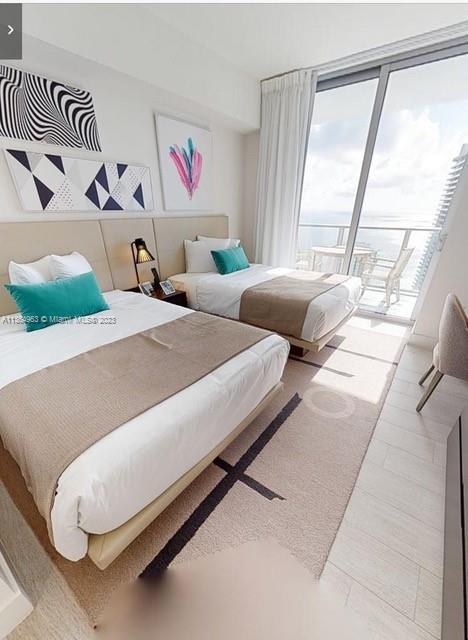 4010 South Ocean Drive, Unit R2305 Hollywood, FL 33019 - Photo 4 of 15 a bedroom with a bed and a large window