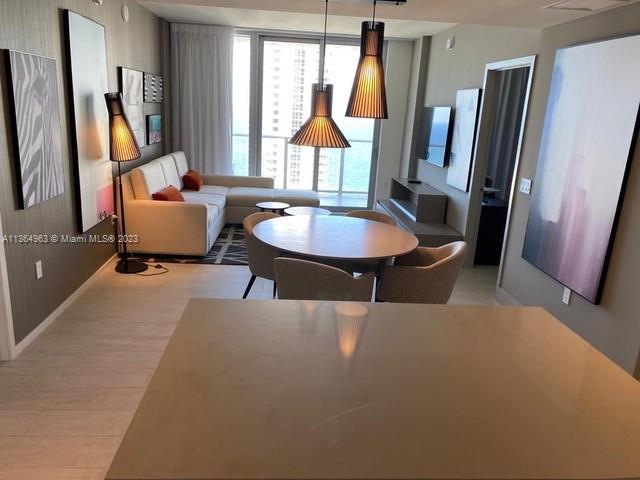 4010 South Ocean Drive, Unit R2305 Hollywood, FL 33019 - Photo 6 of 15 a living room with furniture a window and a flat screen tv
