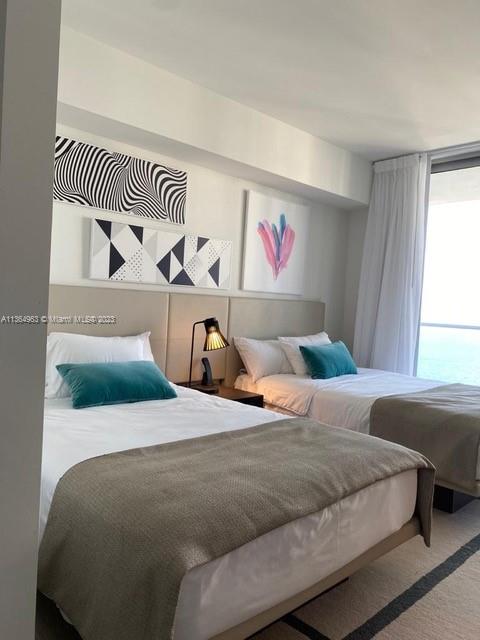 4010 South Ocean Drive, Unit R2305 Hollywood, FL 33019 - Photo 7 of 15 a bedroom with a bed and a window
