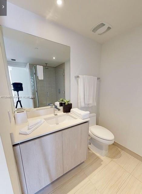 4010 South Ocean Drive, Unit R2305 Hollywood, FL 33019 - Photo 9 of 15 a bathroom with a sink toilet and mirror