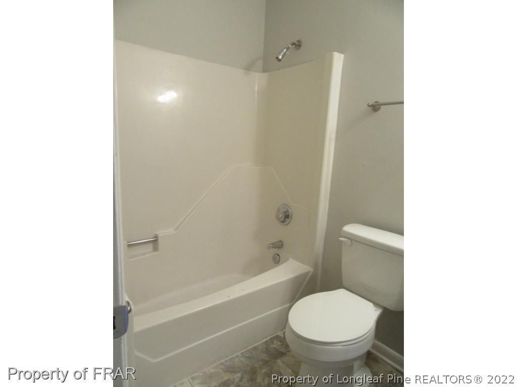 5947 Spinner Road Hope Mills, NC 28348 - Photo 18 of 31 a white toilet sitting next to a bath tub