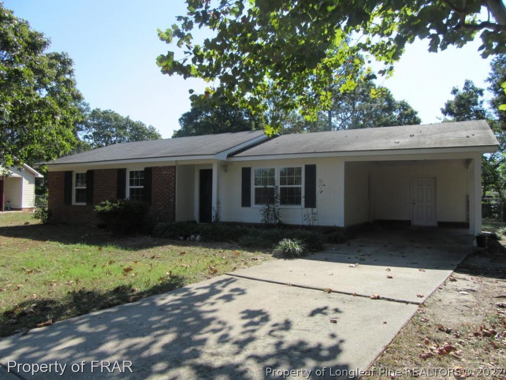 5947 Spinner Road Hope Mills, NC 28348 - Photo 2 of 31 a front view of a house with a yard