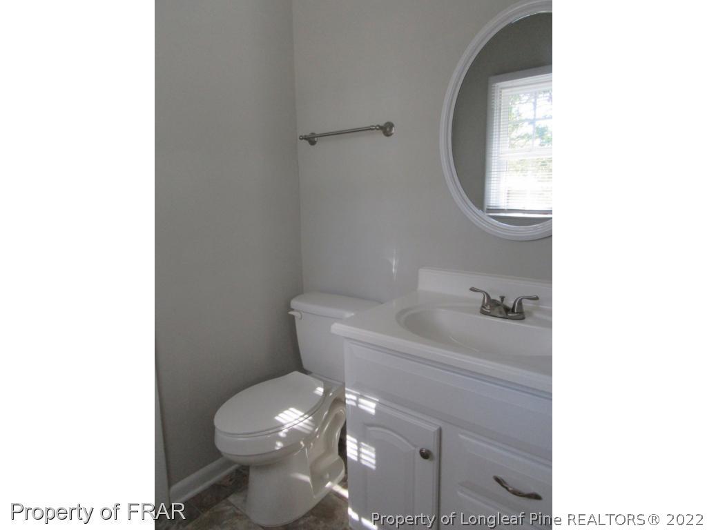 5947 Spinner Road Hope Mills, NC 28348 - Photo 24 of 31 a bathroom with a toilet sink and mirror