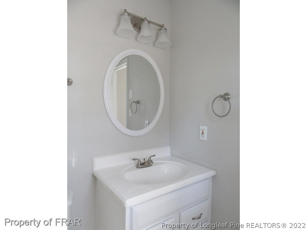 5947 Spinner Road Hope Mills, NC 28348 - Photo 25 of 31 a bathroom with a sink and a mirror