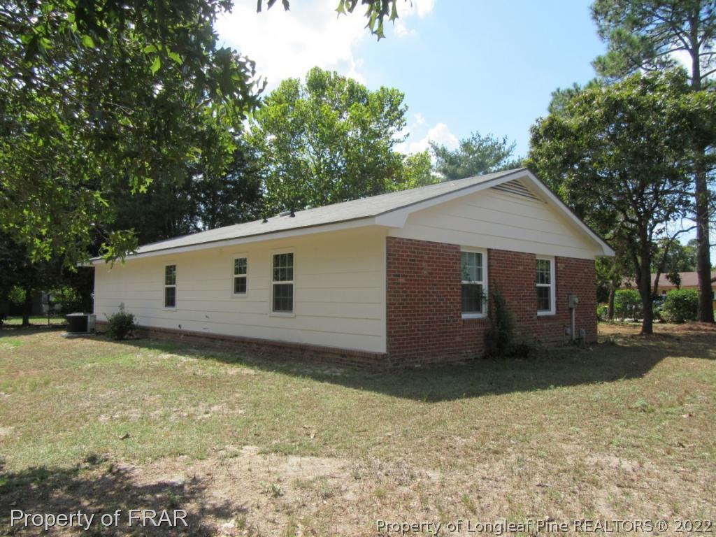 5947 Spinner Road Hope Mills, NC 28348 - Photo 6 of 31 a view of a house with a yard