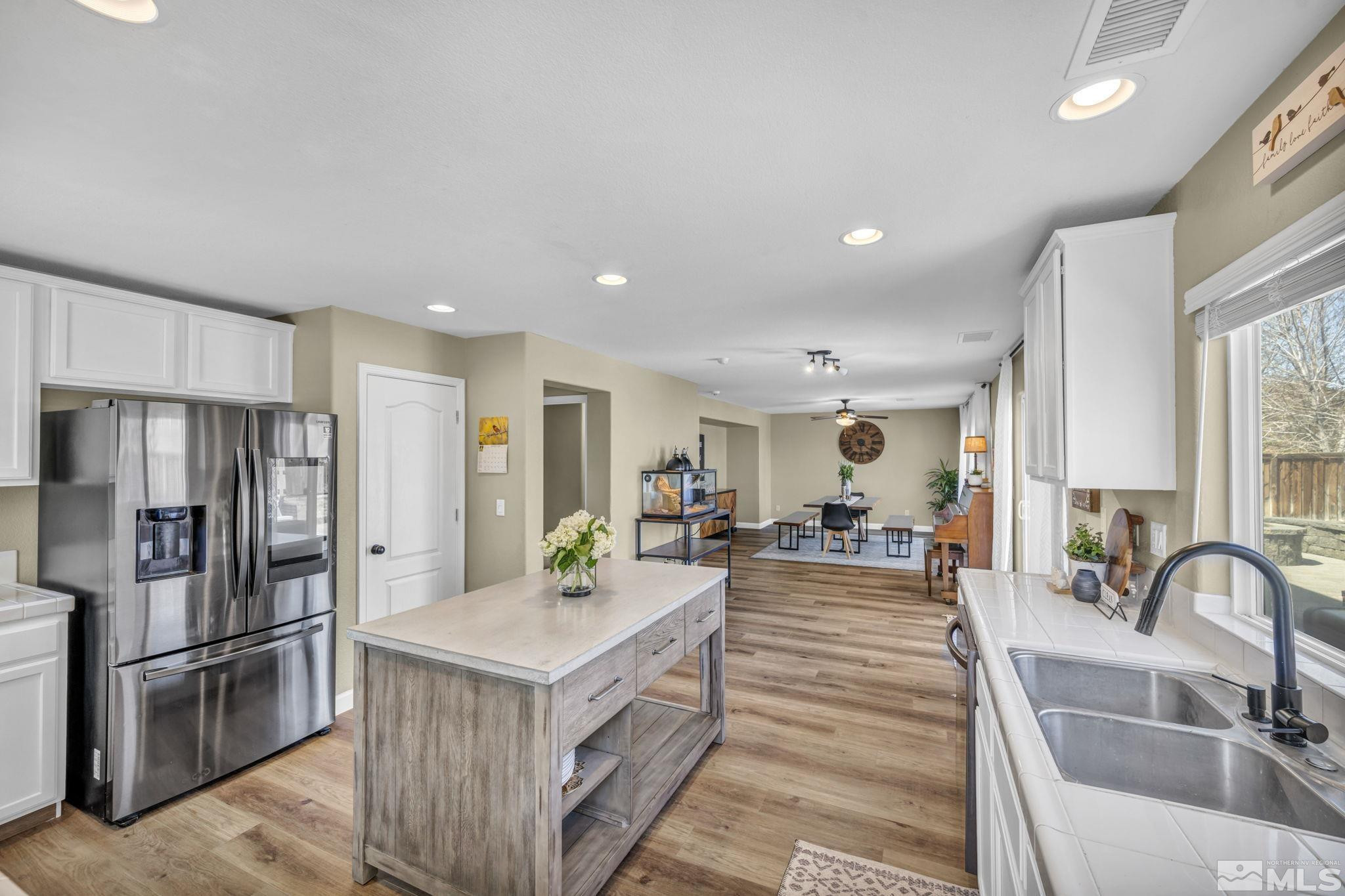485 Sondrio Court Reno, NV 89521 - Photo 11 of 40 a kitchen with stainless steel appliances granite countertop a lot of counter space and a refrigerator